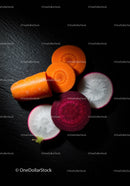 Fresh sliced carrots and radishes on dark surface