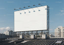 Blank outdoor billboard on urban rooftop under blue sky