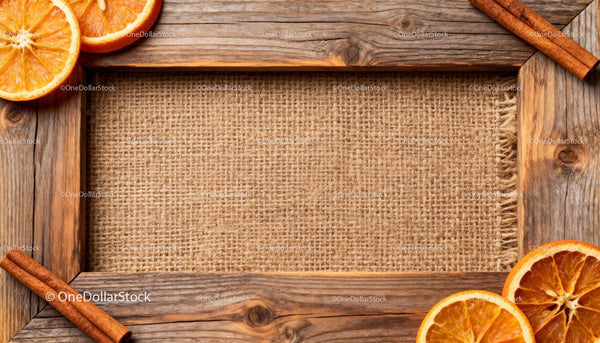 Rustic wooden frame with dried oranges and cinnamon sticks