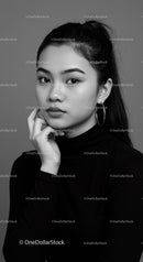 Elegant Young Woman Portrait with Hoop Earrings in Black and White