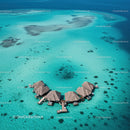 Overwater Bungalows Surrounded by Clear Turquoise Water and Sandy Beaches