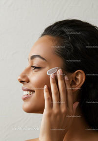Young Woman Applying Moisturizer with a Bright Smile