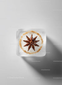 Star Anise Embedded in Clear Ice Cube on White Surface