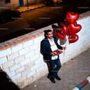 Man Holding Heart Balloons and Chocolates Outdoors