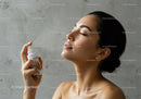 Woman Applying Moisturizer in Skincare Routine with Clear Skin