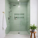 Modern bathroom with glass shower and green tiles