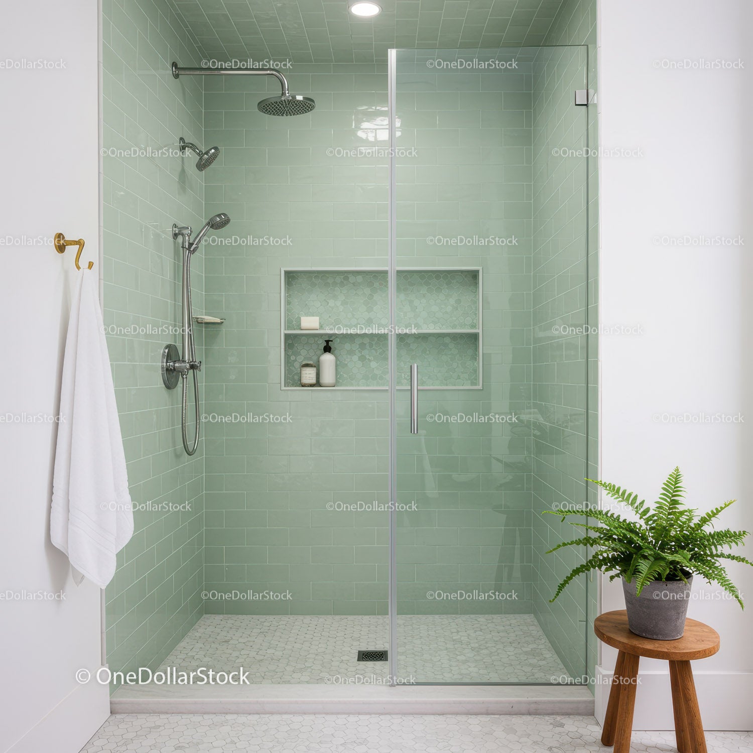 Modern bathroom with glass shower and green tiles