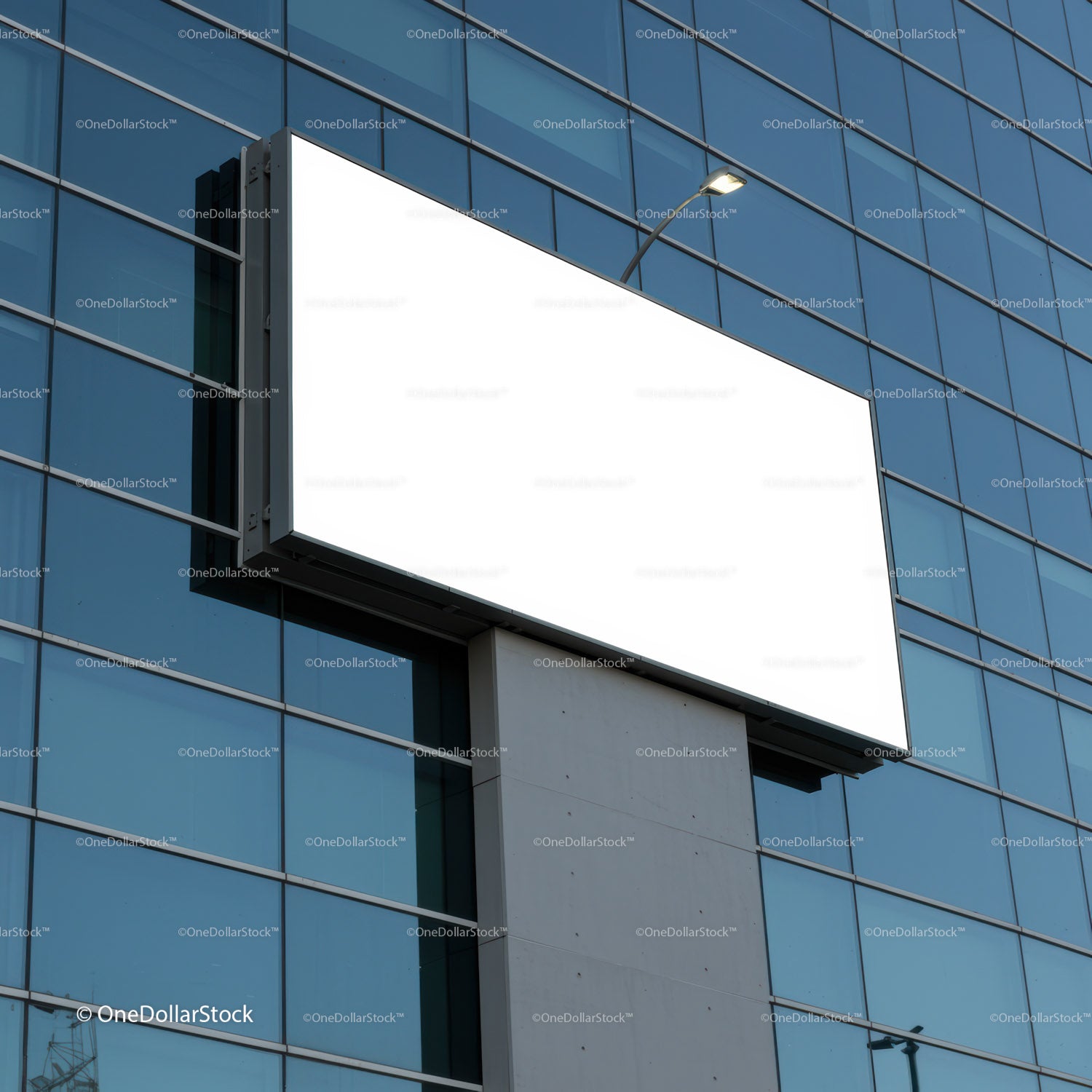 Blank billboard on modern glass building facade