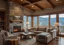Cozy living room with stone fireplace and mountain view