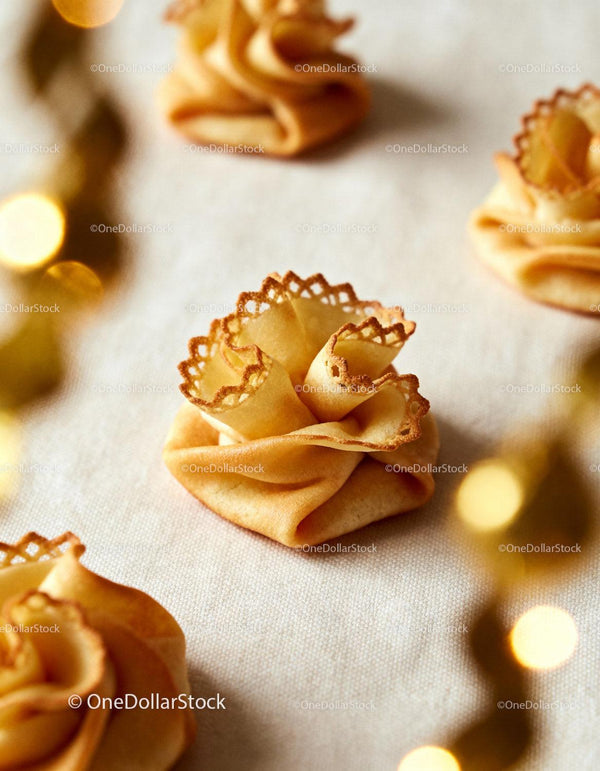 Delicate Golden Crisp Pastries on Light Fabric Surface