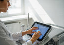 Healthcare Professional Using Ultrasound Machine in Medical Clinic