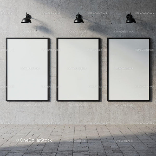 Three blank posters on concrete wall under industrial lights JPG Mockup Image