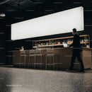Businessman walking past modern bar with laptop