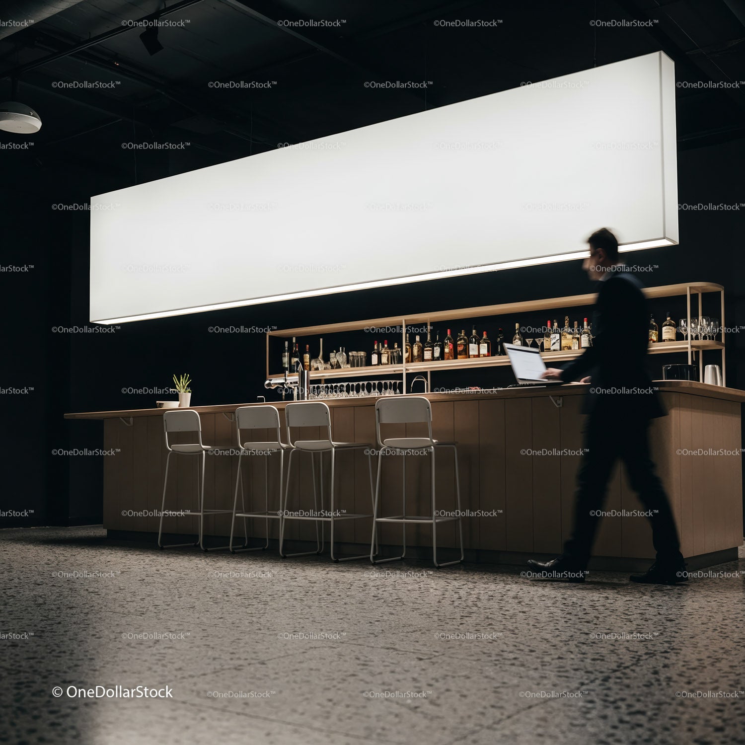 Businessman walking past modern bar with laptop