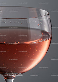 Close up of sparkling rosé wine in elegant glass