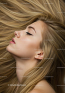 Blonde woman with flowing hair and closed eyes
