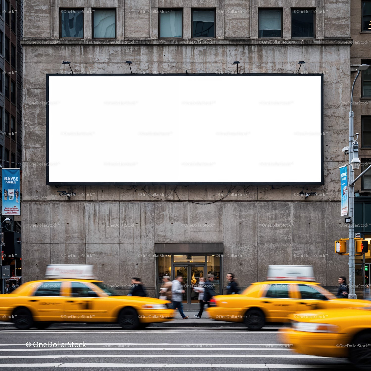 Busy city street with yellow taxis and blank billboard