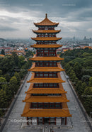 Traditional Chinese Pagoda Tower with Cityscape and Mountain View