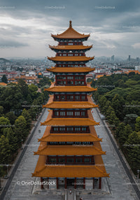 Traditional Chinese Pagoda Tower with Cityscape and Mountain View