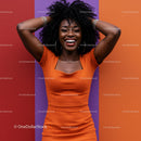 Joyful Woman in Bright Orange Dress with Curly Hair Against Colorful Background