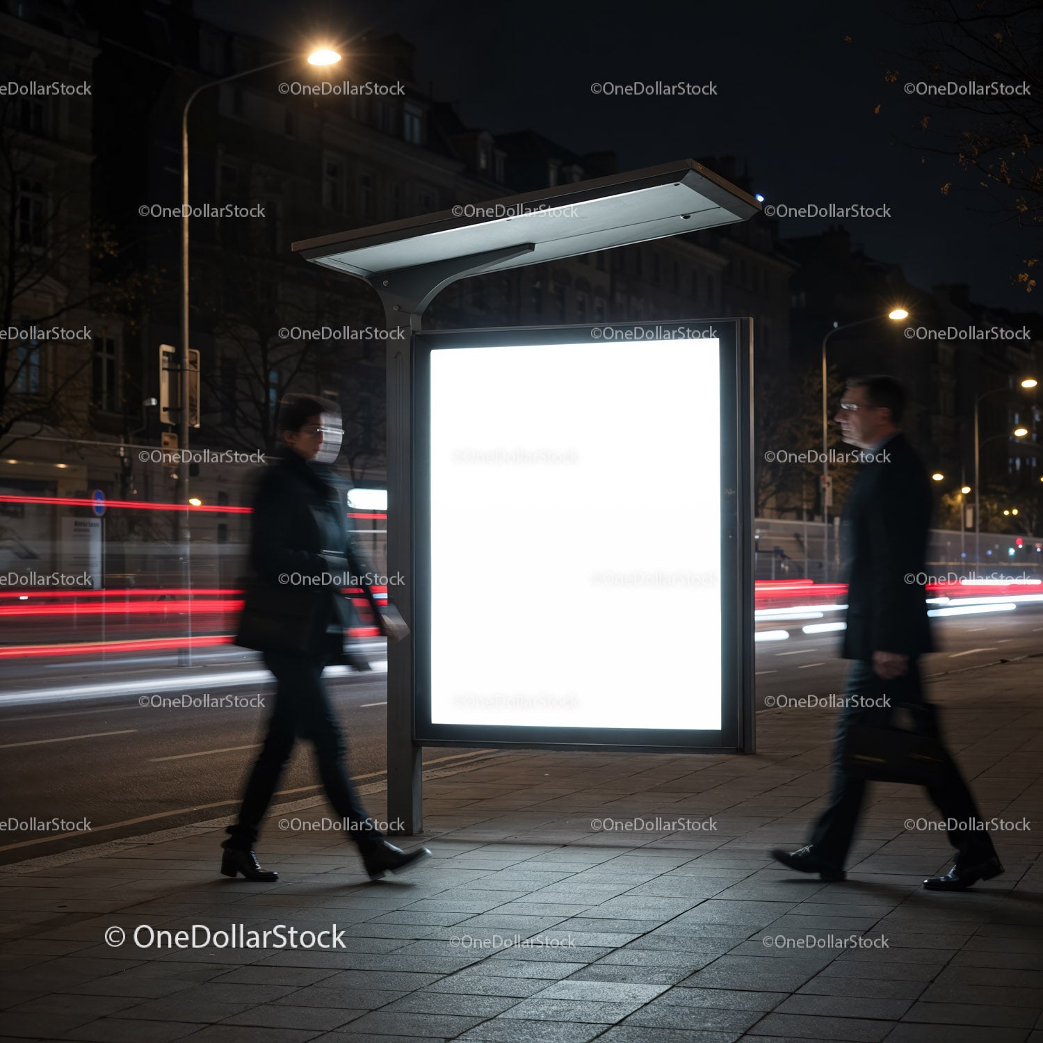 Nighttime city pedestrians passing illuminated bus stop ad