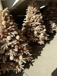 Decorated beige Christmas trees with plush ornaments