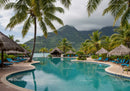 Luxury Poolside Lounge Area Surrounded by Tropical Palm Trees and Mountain Views