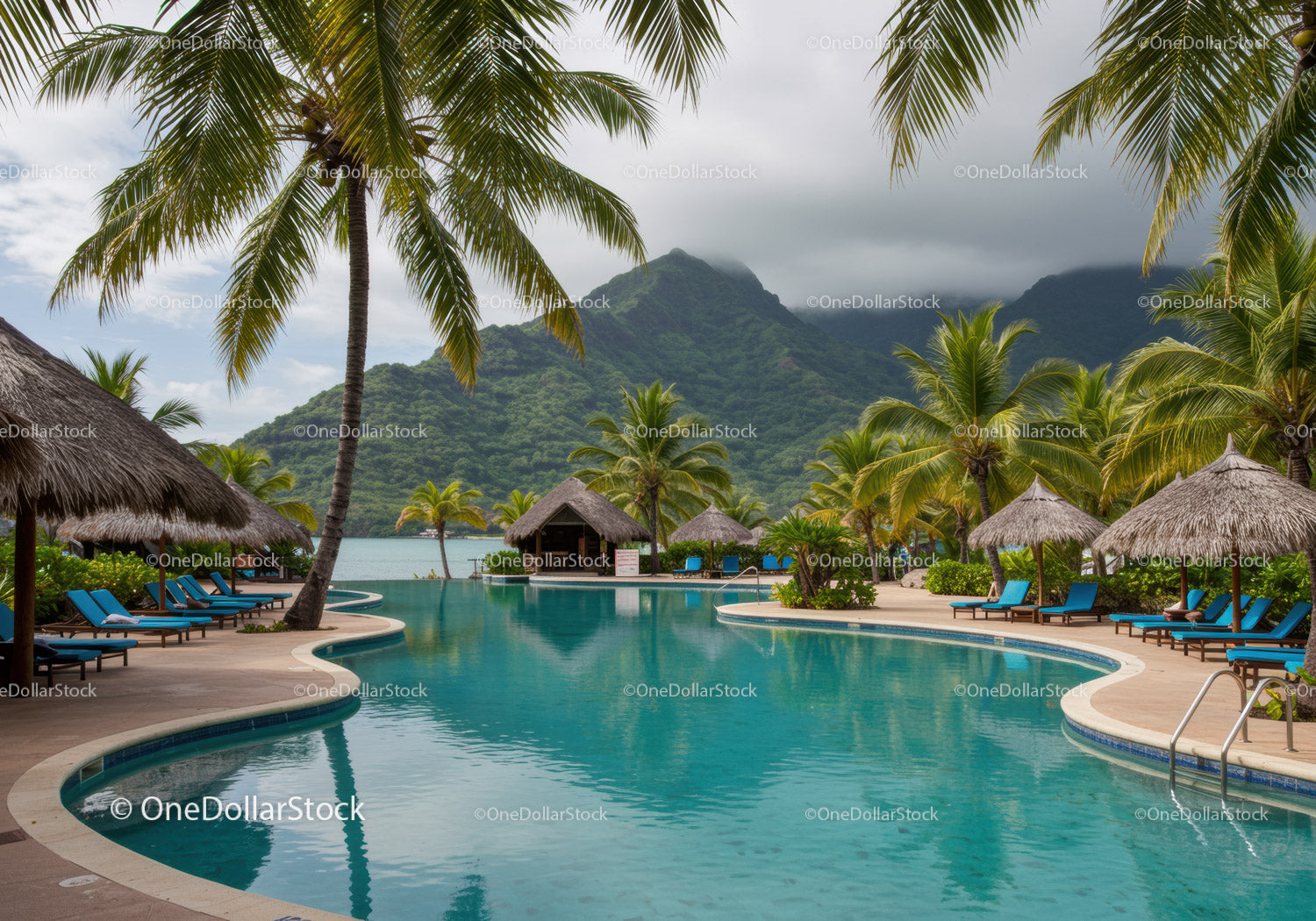 Luxury Poolside Lounge Area Surrounded by Tropical Palm Trees and Mountain Views
