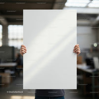 Person Holding Blank White Poster in Bright Office Space