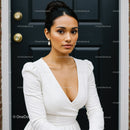 Elegant Woman in White Dress Posing by Black Door