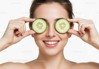 Smiling Woman Holding Fresh Cucumber Slices for Natural Skincare