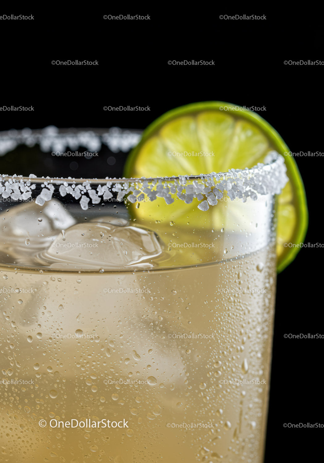 Refreshing cocktail with salted rim and lime slice