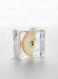 Fresh Apple Slice Captured Inside Melting Ice Cube