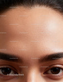 Closeup of smooth forehead and expressive dark eyes
