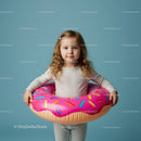 Little girl standing with a colorful donut float ring