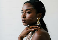 Elegant Black Woman Wearing Statement Pearl Earrings and Sleek Hair