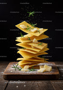 Stacked fresh pasta sheets with rosemary and parmesan