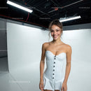 Young Woman in White Dress Smiling in Studio for Fashion Portrait