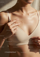 Close-Up of Woman Applying Gel for Breast Skincare in Beige Lingerie