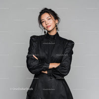 Elegant Woman in Black Dress with Jewelry in Studio