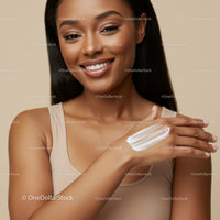 Portrait of a Smiling Woman Applying Lotion for Healthy Glowing Skin