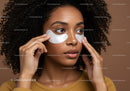 Young woman applying eye patches for skincare and beauty routine