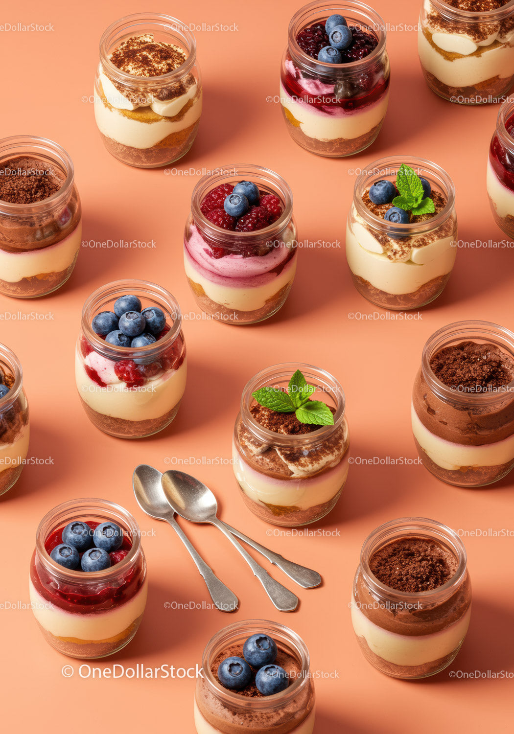 Assorted layered desserts in jars with fresh berries