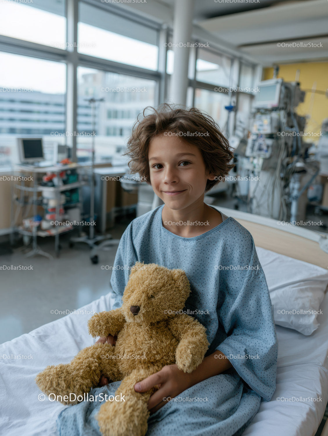 Smiling Young Boy in Hospital Gown Holding Teddy Bear in Medical Room