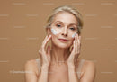 Elegant Mature Woman Applying Facial Cream for Skin Care