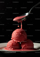 Red berry sorbet scoops with dripping sauce on spoon