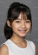 Young Girl with Braces Smiling Portrait with Grey Background