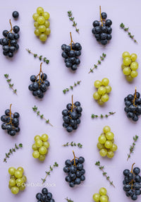 Green and Black Grapes with Fresh Herb Sprigs on Lilac