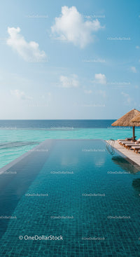 Serene Oceanfront Infinity Pool with Wooden Deck and Straw Umbrella