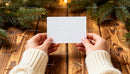 Hands Holding Blank Card Amidst Pine Branches on Wood JPG Mockup Image preview